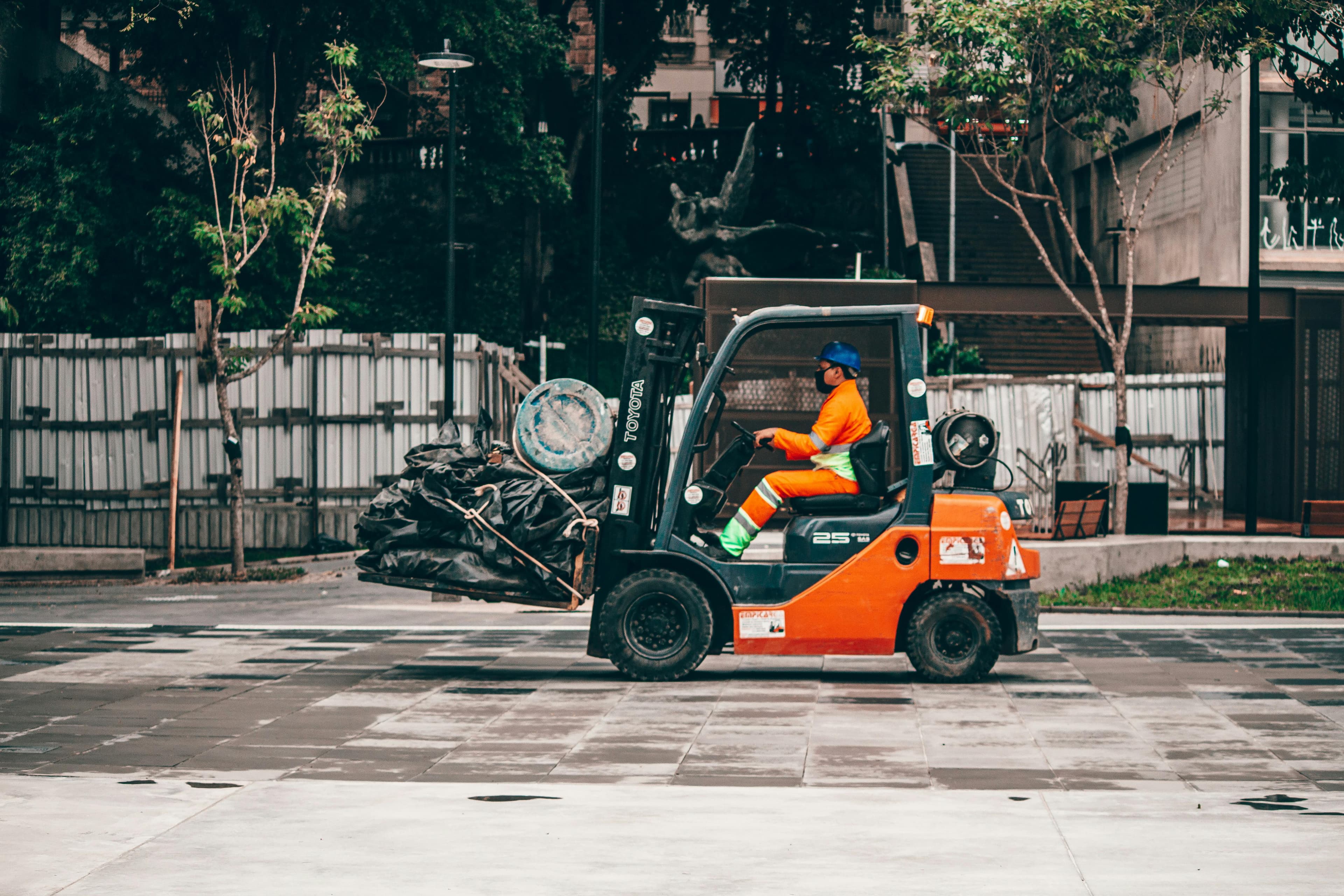 A forklift moving a pallet across a loading yard