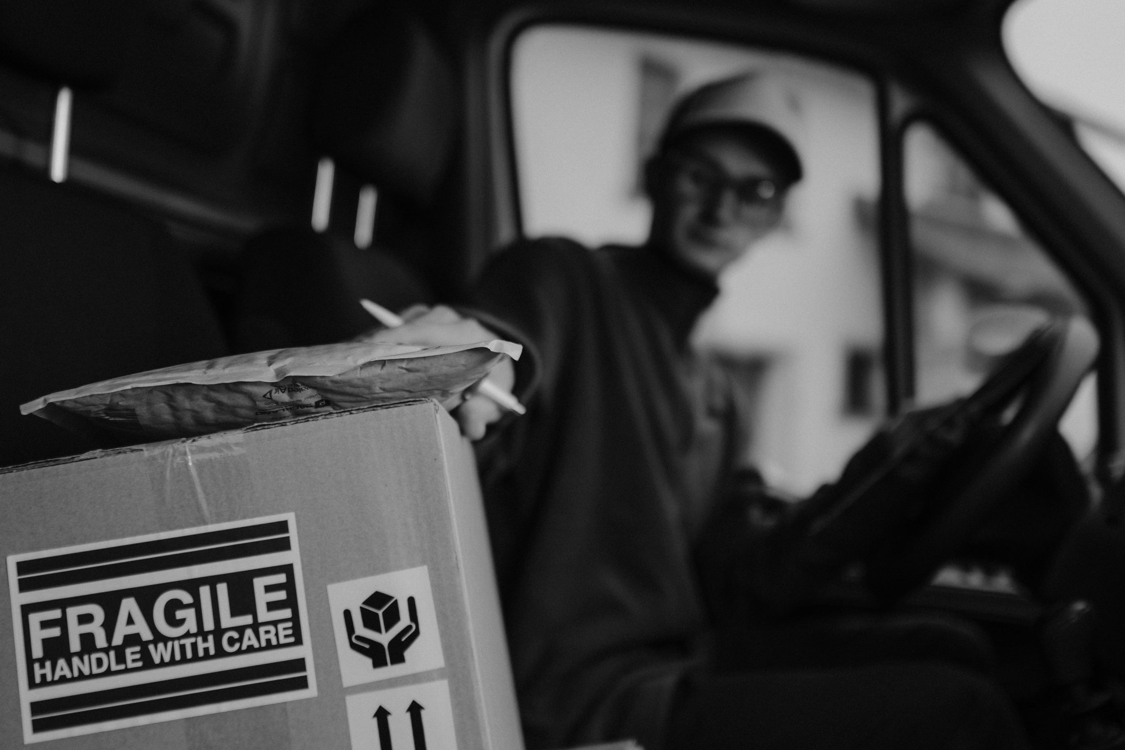 A fragile parcel being loaded into a van